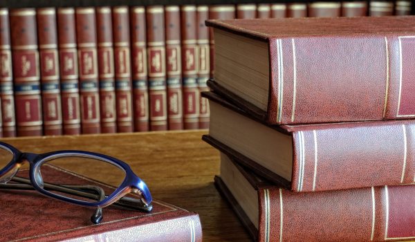 books on the table and classes and the bottom shelf